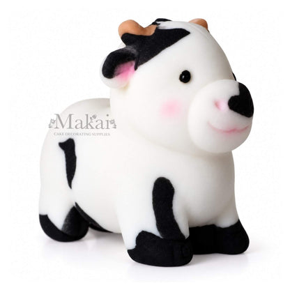 Large black and white cow fondant cake topper for farm themed birthday cakes