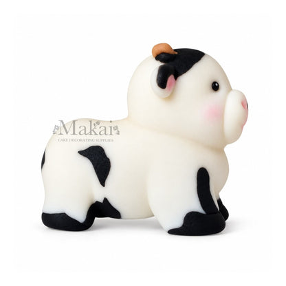Large black and white cow fondant cake topper for farm themed birthday cakes
