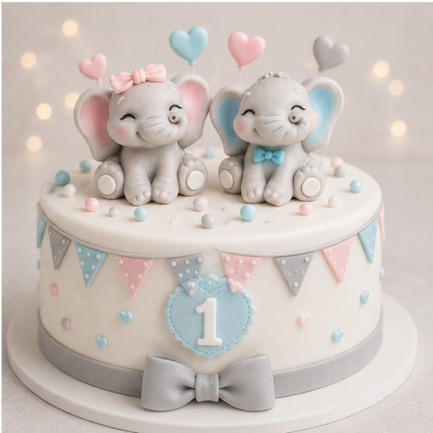 Cake with elephant boy and girl decorations and colourful elements on a light background