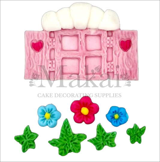 Edible fondant fairy window, pink flowers, and green leaves cake toppers for enchanted garden-themed cakes.