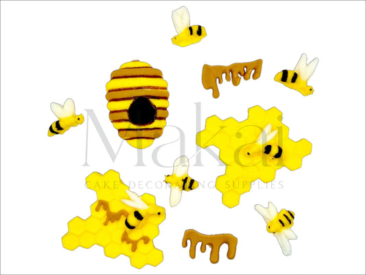 Fondant bee and honeycomb decoration set with bees, hive, honey drips, and hexagonal honeycomb shapes for cake decoration.