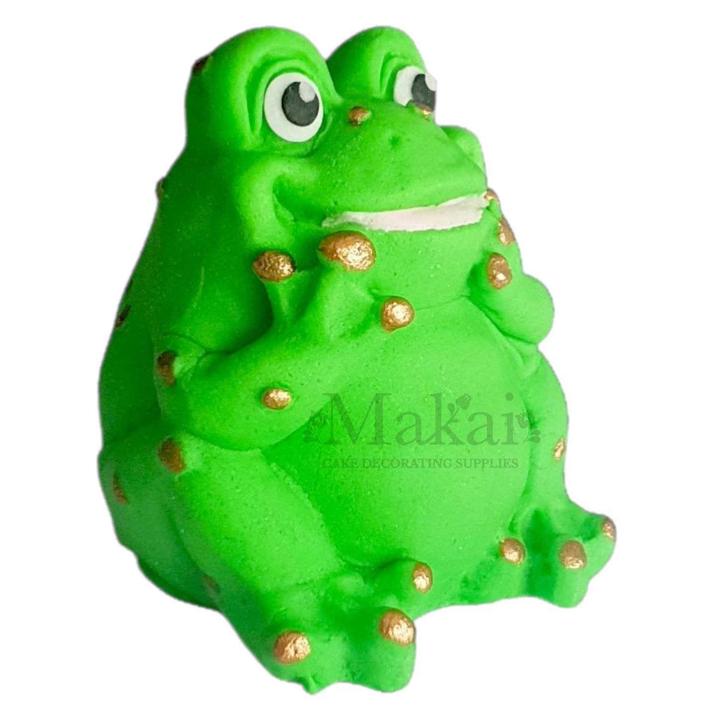 Green fondant frog cake topper with gold spots sitting pose