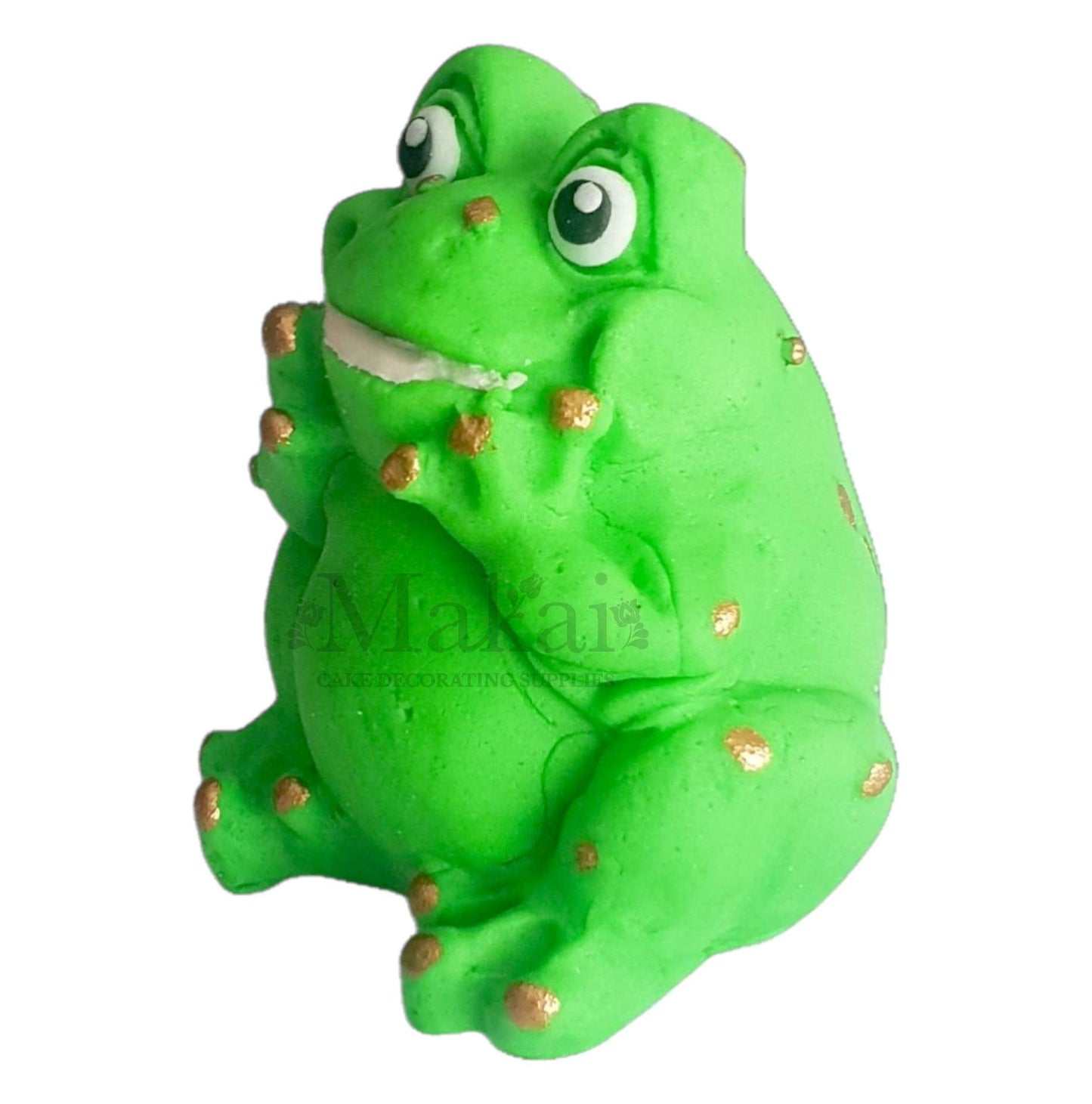 Side view of green fondant frog cake topper with gold spots