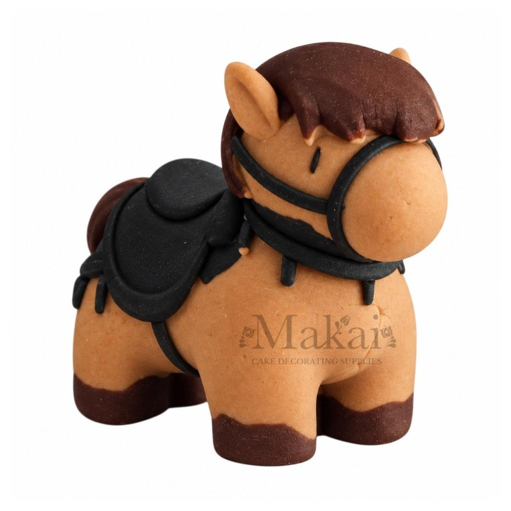 Handmade fondant horse cake decoration with brown mane, black saddle and bridle, front angle view.