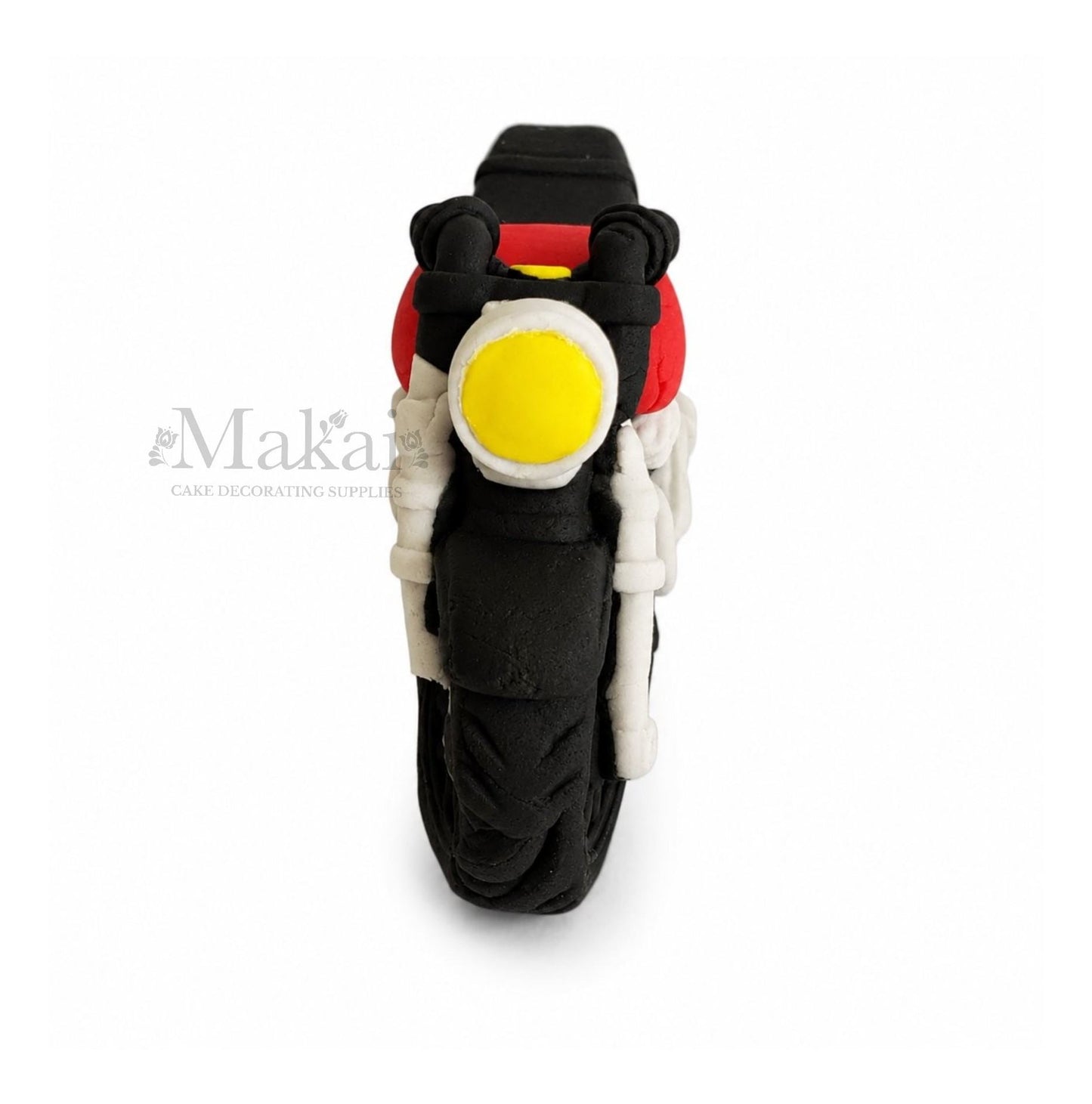 Motorcycle cake topper with a yellow light on a white background