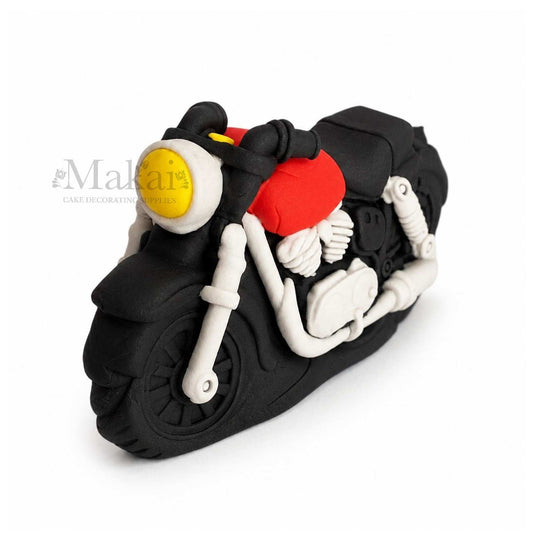 Motorcycle-shaped cake decoration on a white background