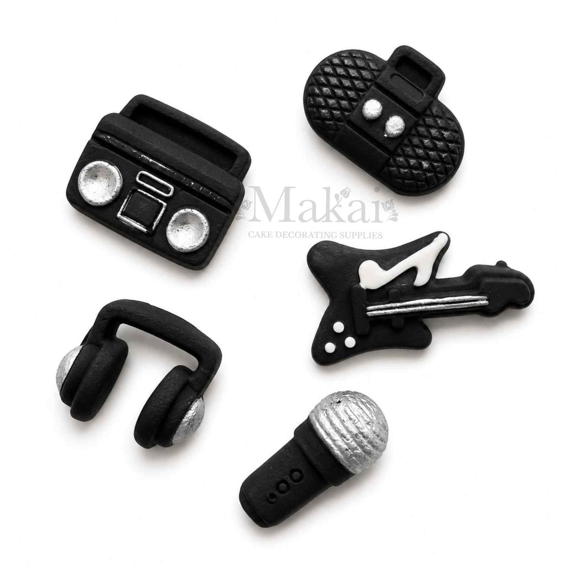 Black and silver fondant music cake decorations with guitar microphone headphones and radios