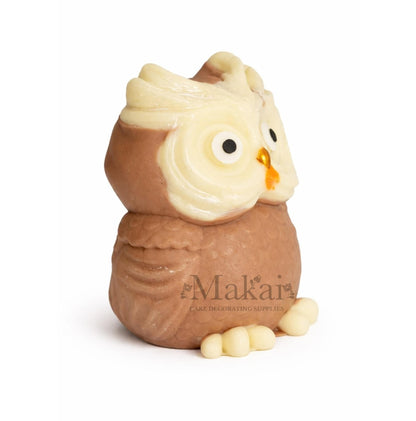 Side view of a fondant owl cake topper in cream and soft brown colours