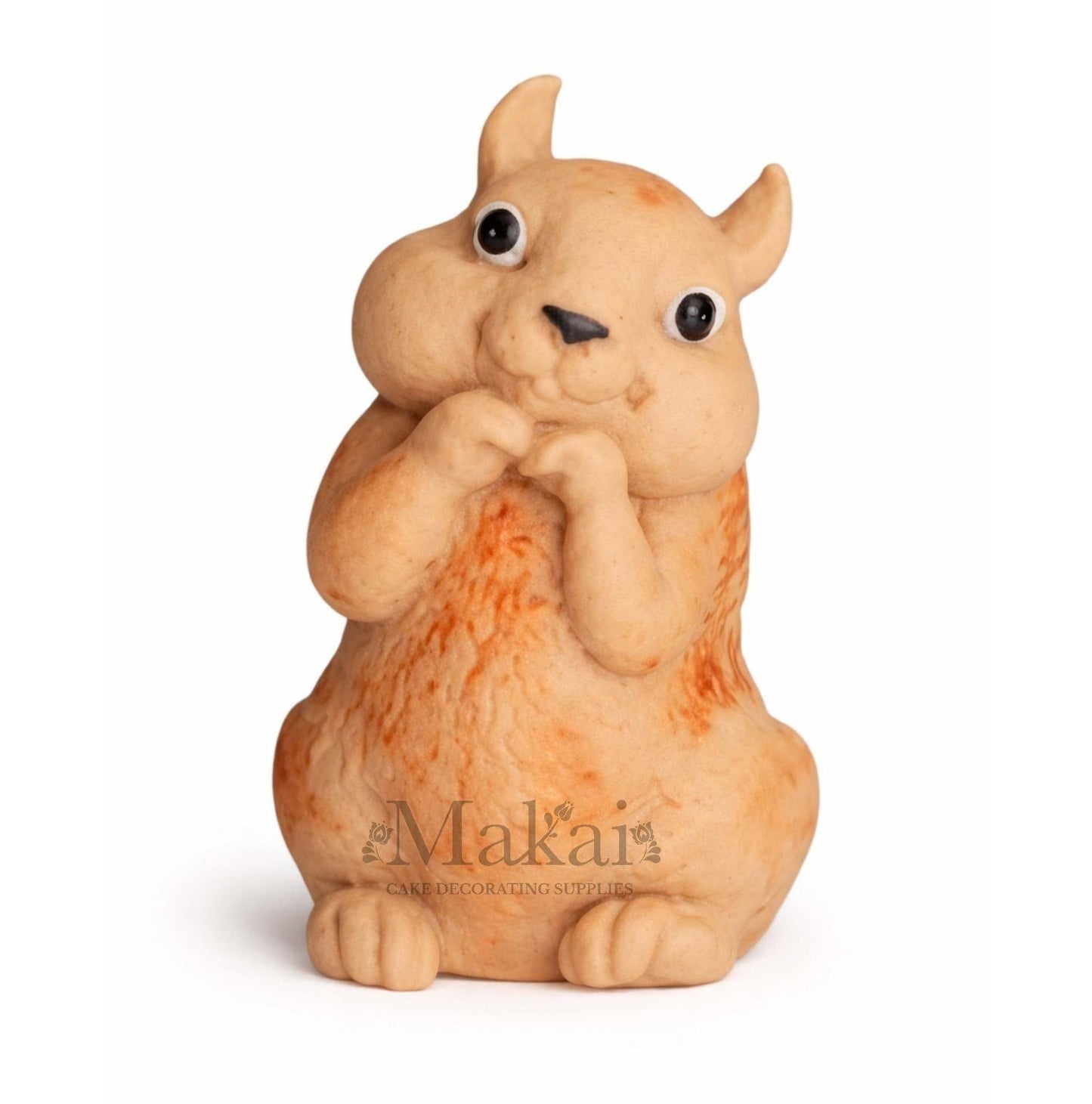 Front view of a fondant squirrel cake topper in soft cream and orange tones