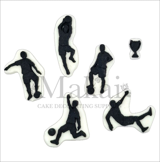 Black and white football silhouette cake toppers with players in action poses and a small trophy.