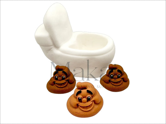Fondant toilet cake topper with open lid, accompanied by three smiling poo decorations.