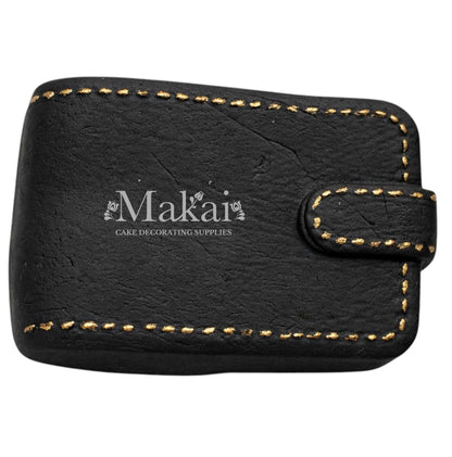 Black gentleman wallet cake topper with gold stitching details for luxury birthday cakes