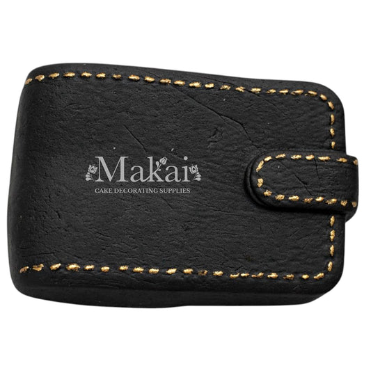 Black gentleman wallet cake topper with gold stitching details for luxury birthday cakes