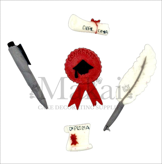 Edible graduation-themed fondant cake toppers including diplomas, a feather pen, modern pen, and red badge.