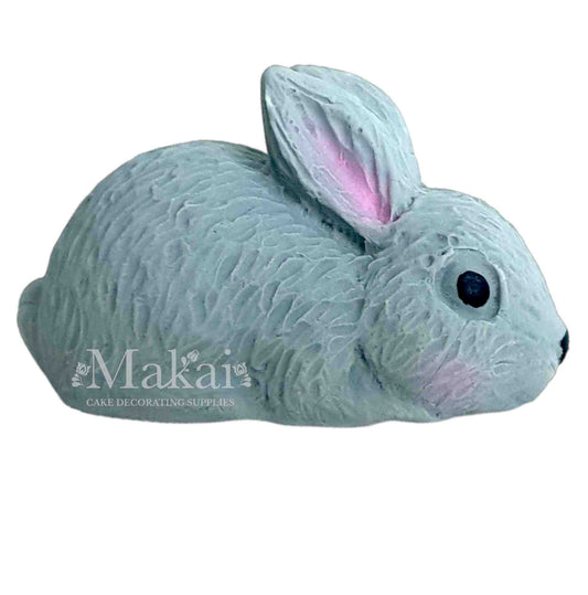 Grey bunny cake topper decoration on a clean white background