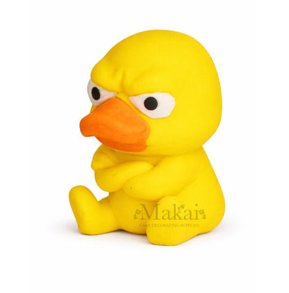 side view of grumpy yellow duck cake topper edible cake decoration