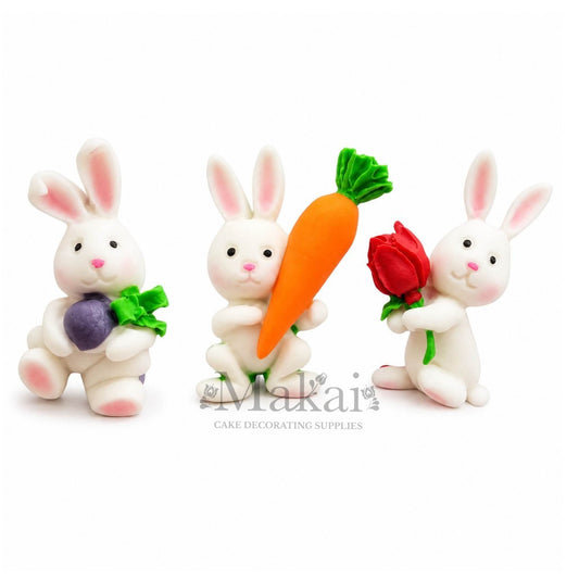 Handmade fondant bunny rabbit cake decorations with carrot, radish and rose for Easter, spring and animal themed cakes