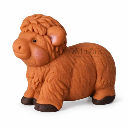 Large Highland cow fondant cake topper with brown textured fur for farm themed cakes. Side view again
