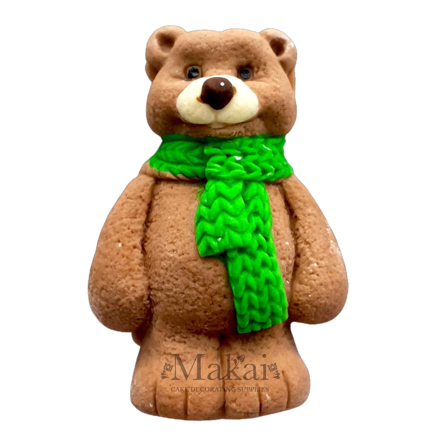 Handmade brown fondant bear cake topper with a bright green knitted scarf, perfect for Christmas or winter-themed cakes.
