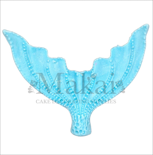 Large edible blue mermaid tail cake topper with detailed texture, perfect for ocean and fantasy cake themes.