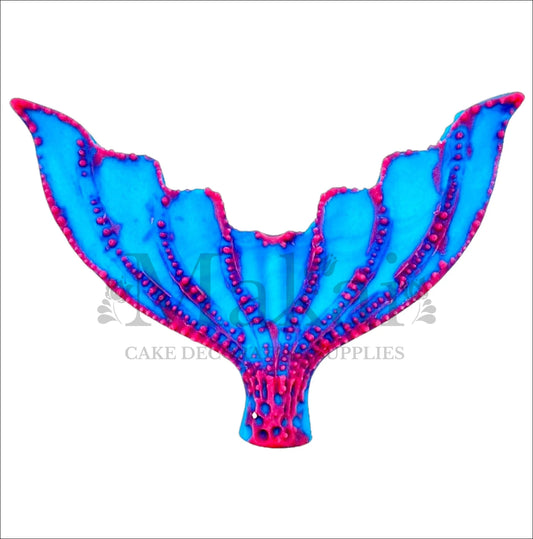 Edible mermaid tail cake topper in bright blue with bold pink accents, perfect for ocean-themed or fantasy cakes.