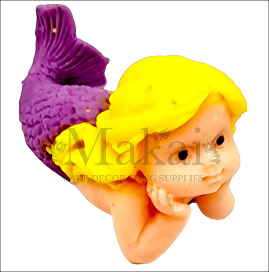 Edible lying mermaid baby cake topper with purple tail and blonde hair, perfect for ocean and fantasy-themed cakes.