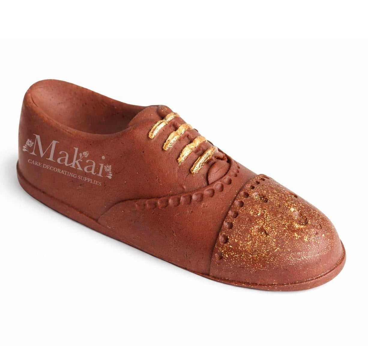 Angled view of a brown gentleman shoe cake topper with gold details, shown from the side and slightly from above