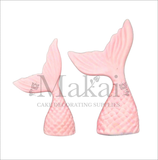 Two baby pink edible mermaid tail cake toppers, perfect for fantasy and ocean-themed cake decorations.
