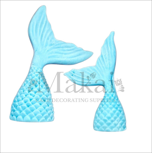 Set of two edible blue mermaid tail cake toppers, ideal for under-the-sea and ocean-themed cake decorations.