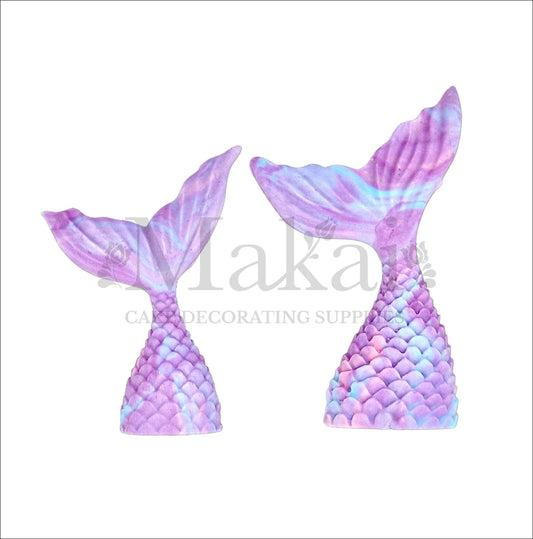 Set of two edible mermaid tail toppers in purple and blue marble effect, ideal for fantasy or ocean-themed cakes.