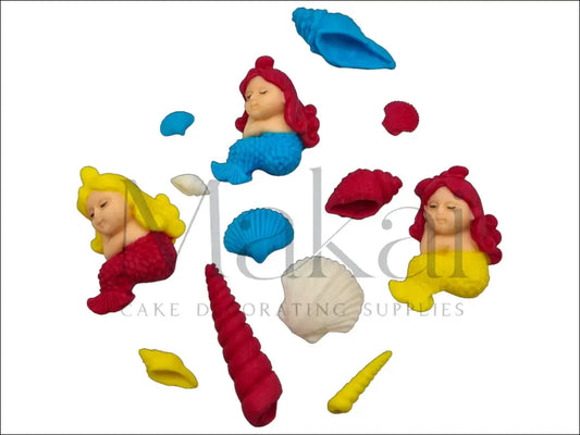 A vibrant mini mermaid cake topper set featuring three small mermaids in bold pink, yellow, and deep blue tones, accompanied by beautifully detailed seashells, perfect for a lively ocean-themed cake.