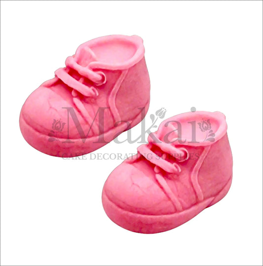 Edible fondant pink baby shoes cake topper set for girl baby‑shower and birthday cakes.