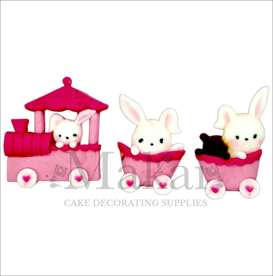 Edible pink bunny train cake topper set with baby rabbits in locomotive and wagons for baby‑shower cakes.