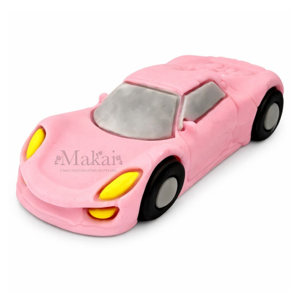 Edible baby‑pink sport car fondant cake topper for racing and kids’ birthday cakes.