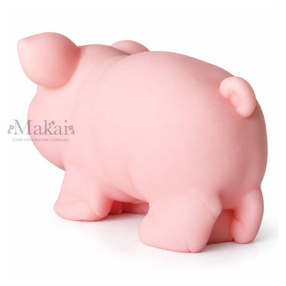 Large pink pig fondant cake topper with curled tail for farm themed birthday cakes