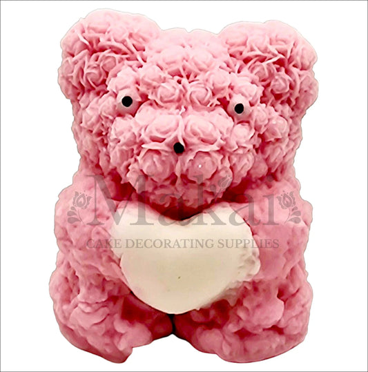 Pink rose bear edible cake topper holding a white heart, perfect for romantic and birthday cakes.