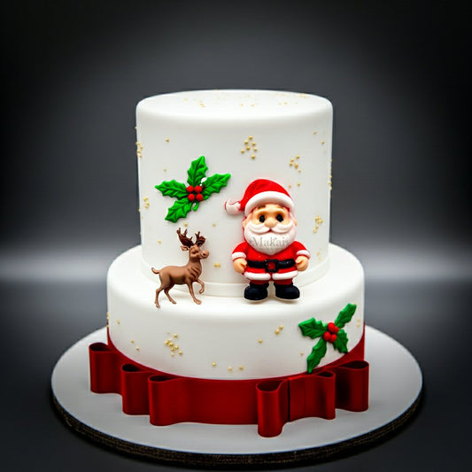 Two-tiered Christmas cake with Santa Claus and reindeer decorations on a dark background by Makai Cake Decorating Supplies