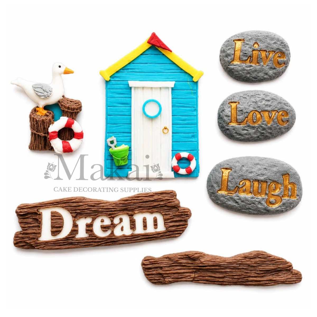 Handmade seaside fondant cake decorations with beach hut, seagull, lifebuoy and Dream Live Love Laugh plaques for themed cakes