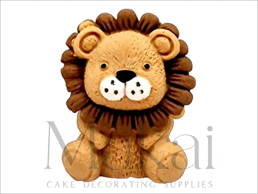 Handmade fondant sitting lion cake topper with a golden mane and cute facial expression.