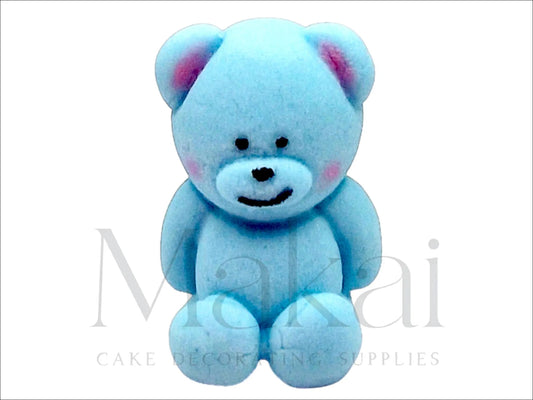 Blue fondant teddy bear sitting upright with a sweet expression, perfect for baby-themed cakes.