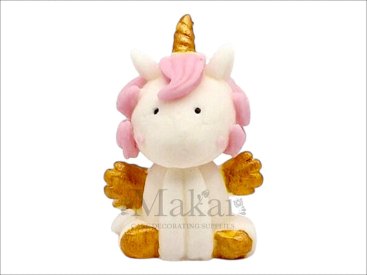 Sitting edible unicorn cake topper with white body, pink mane, golden horn and wings – fantasy cake decoration