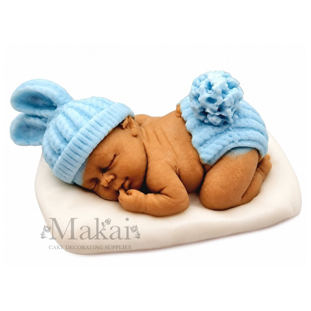 Sleeping baby blue fondant cake topper on white cushion for baby shower and christening cakes