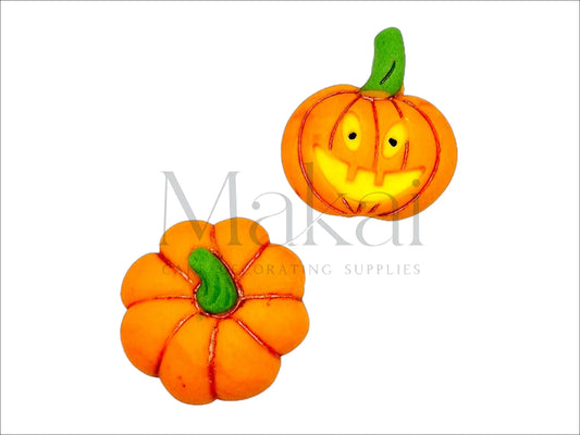 Two edible Halloween pumpkin cake toppers – one smiling jack-o'-lantern and one top-view pumpkin