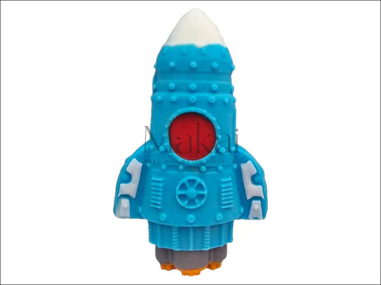 A blue spaceship cake topper with a white nose, orange flames, and grey exhaust, perfect for space-themed cakes.