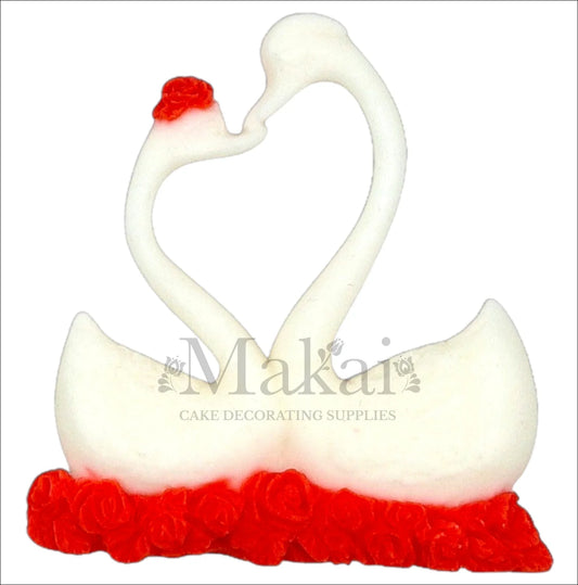 Pair of white swans forming heart shape on red rose base cake topper.