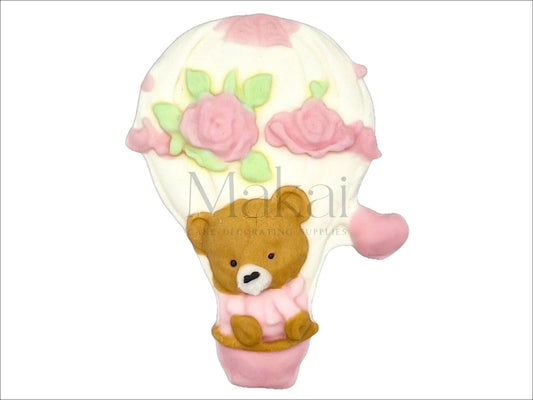 Pink fondant hot air balloon cake topper with teddy bear, roses, and heart details – edible decoration