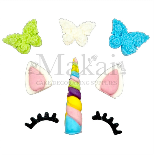 Unicorn horn, ears, eyelashes, and butterfly edible cake decorations in vibrant rainbow colours for fantasy-themed cakes.